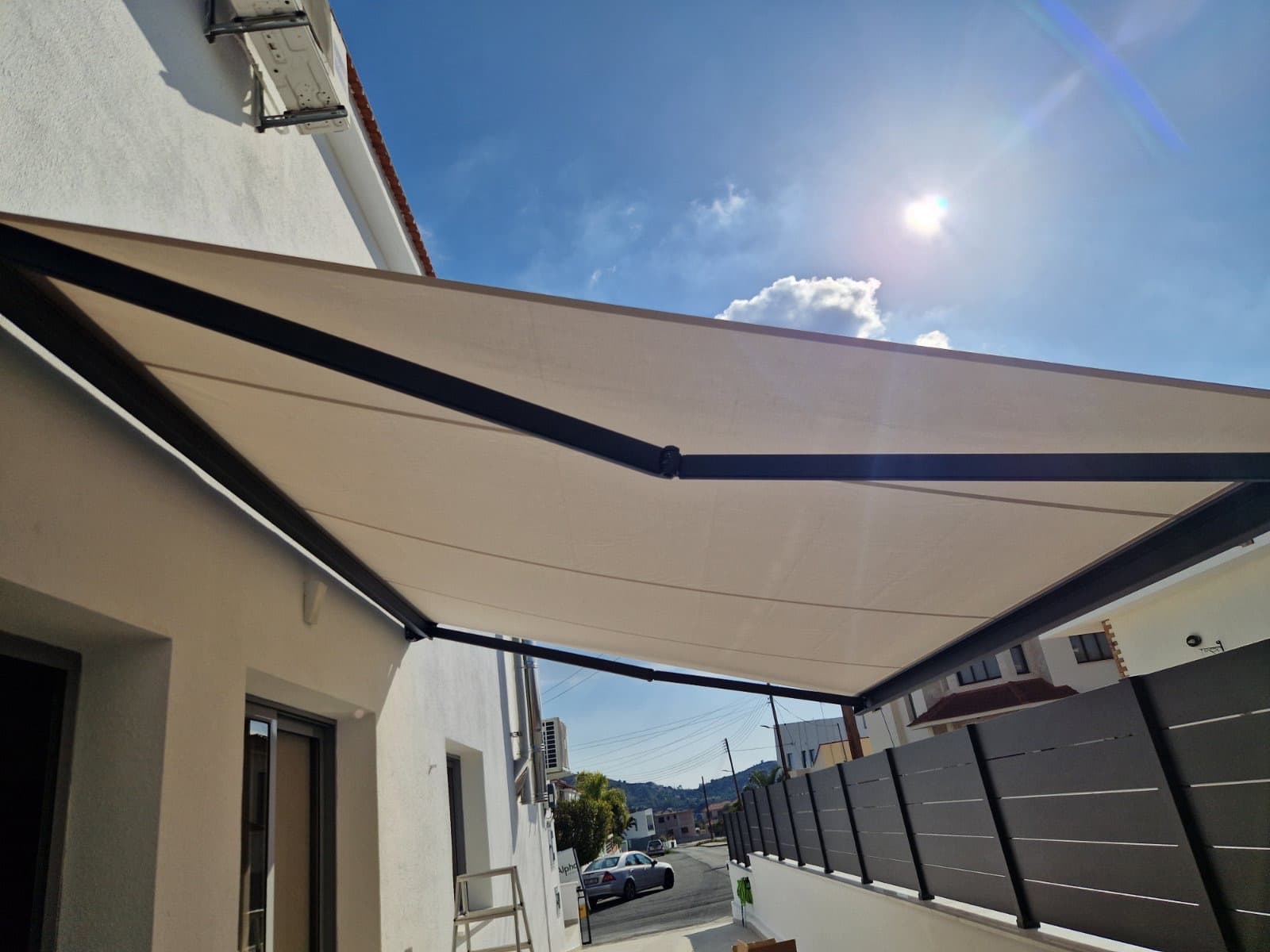 Outdoor awning or shade structure installed above a patio area